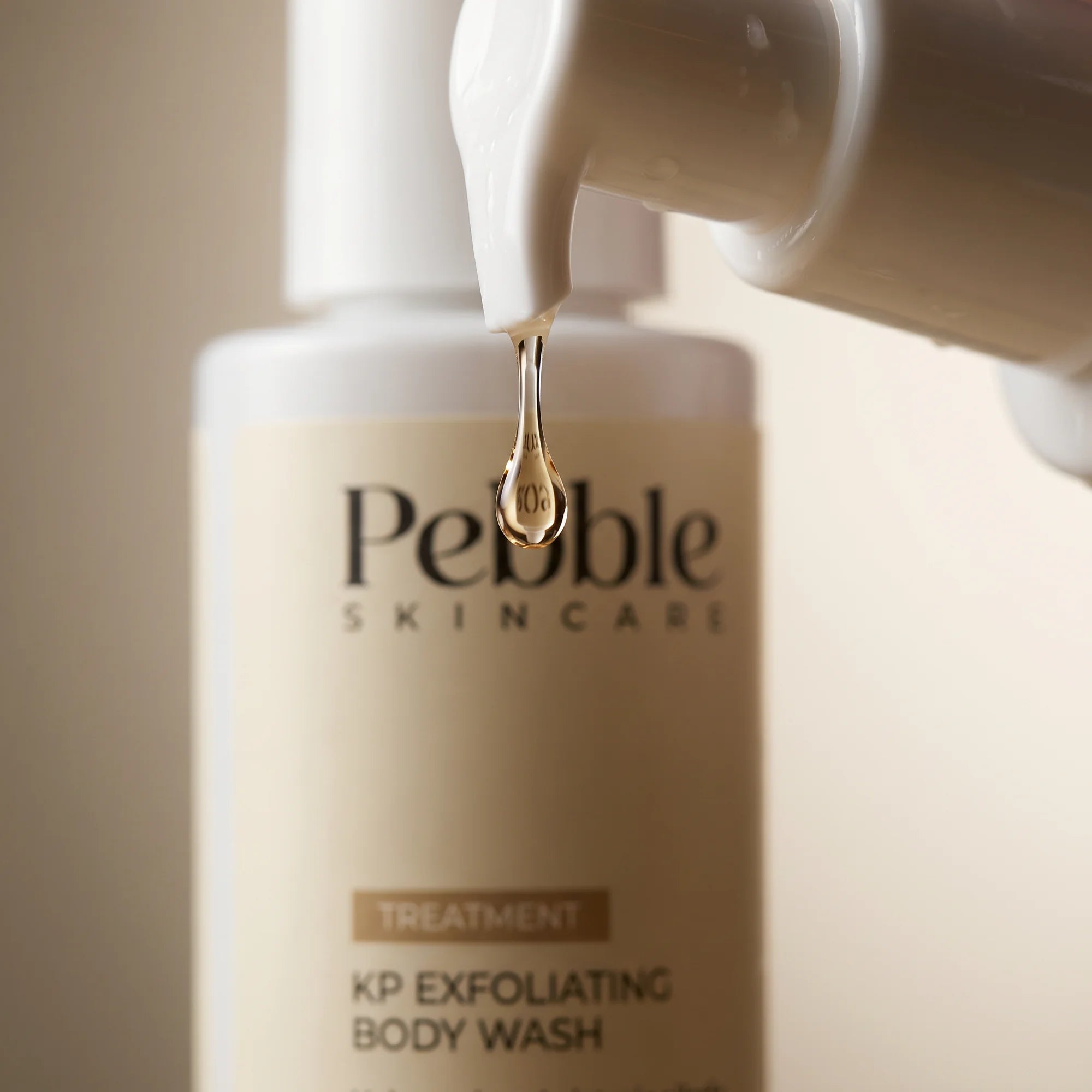Macro shot of the Pebble bottle label, showing 4% Glycolic + 2% Salicylic Acid.