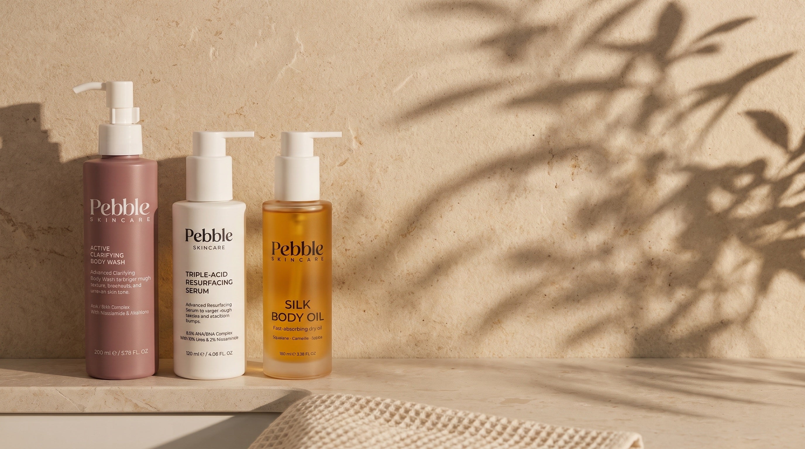 The Pebble routine — Active Clarifying Body Wash, Triple-Acid Resurfacing Serum and Silk Body Oil