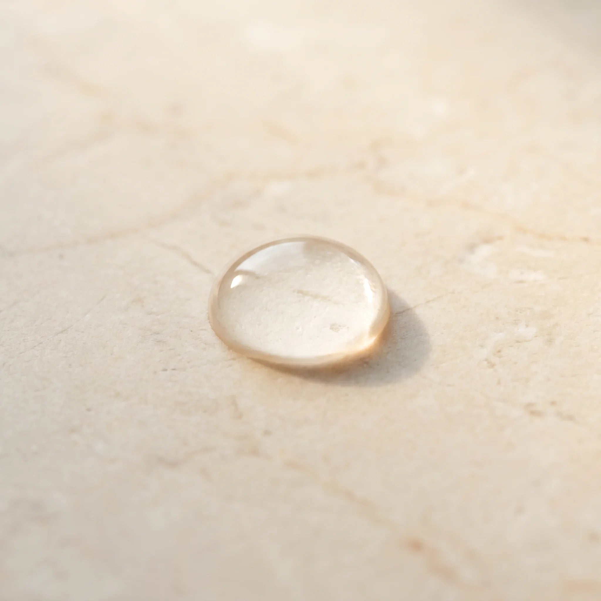 Glycolic acid — clear droplet on travertine