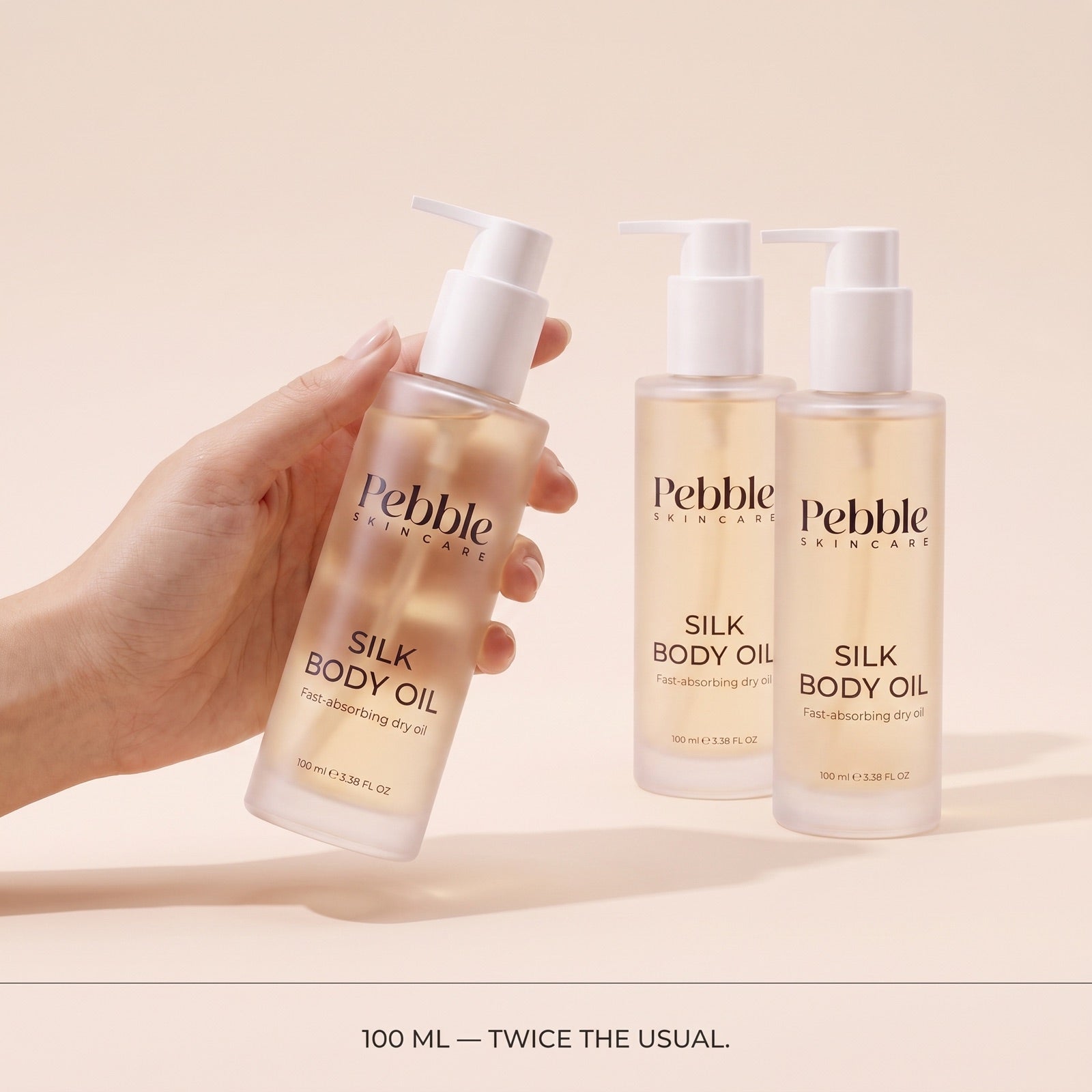 Silk Body Oil bundle and size in hand