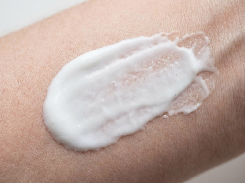 Body lotion sitting on top of skin
